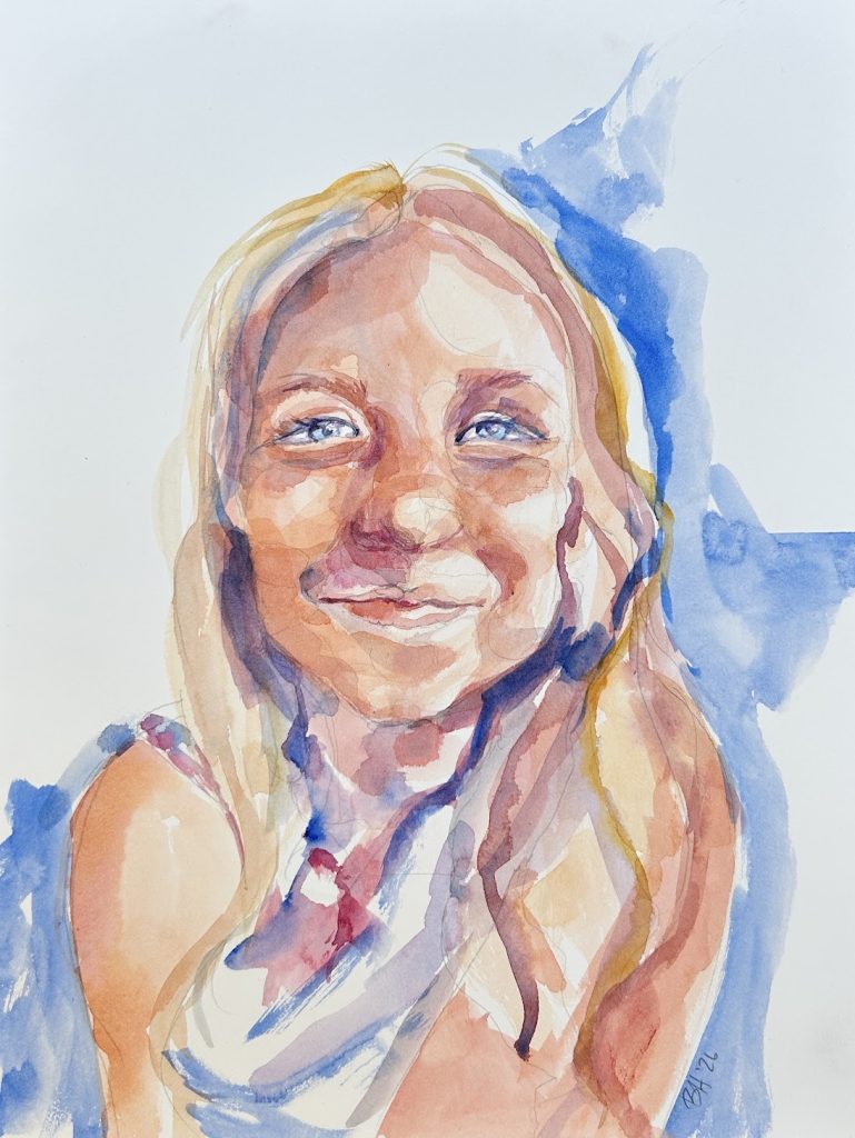 Little girl with bright blue eyes smiling confidently